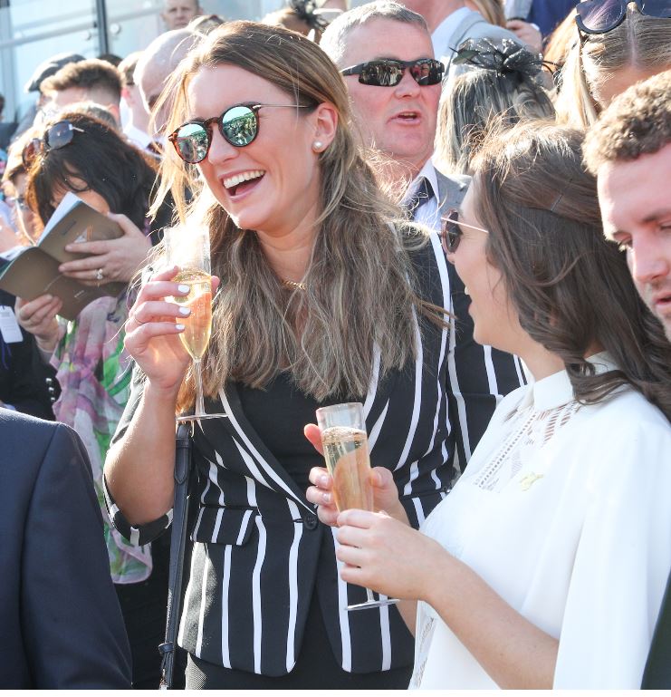 Two women drinking champagne wearing sunglasses 